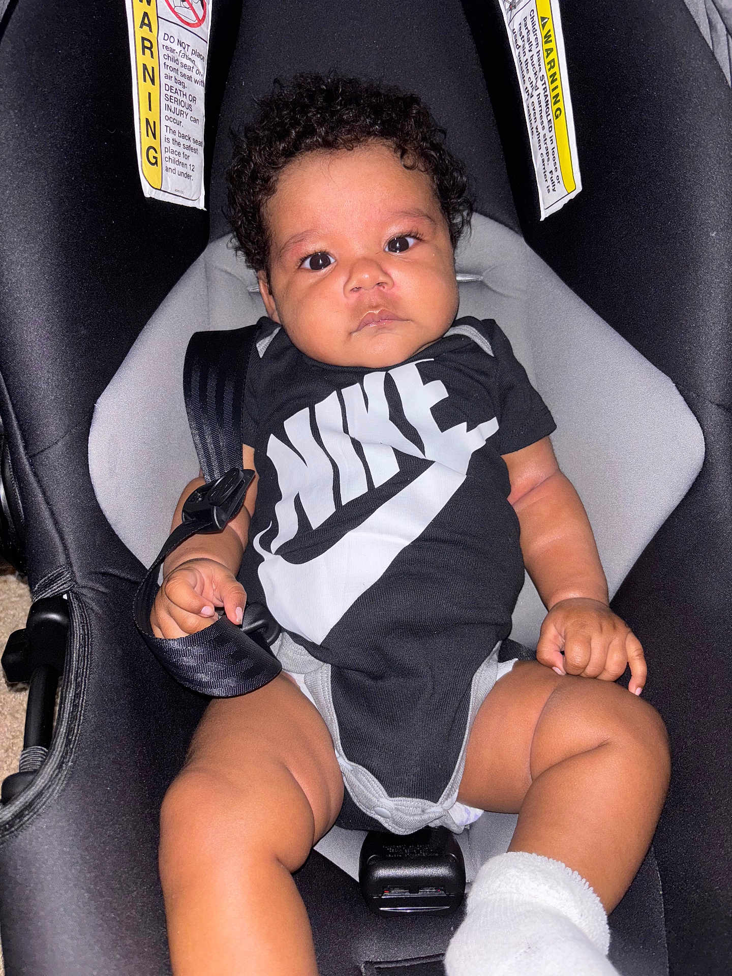 Sevyen joined the competition — help win amazing prizes! baby, black_clothing, car_seat, child, curly_hair, cute, face, hand, indoor, infant, legs, nike, onesie, portrait, safety, sitting, sock, straps, toddler, young
