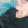 Luna is registered to the contest to win money with this photo: person, cat, black_cat, glasses, sleeping, smile, bed, blanket, indoor, resting, closeup, face, comfort, relaxation, cute, nap, feline, human, cozy, casual
