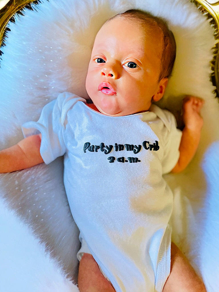 Josiah James is registered to the contest to win money with this photo: baby, bed, blanket, bodypart, clothing, cradle, crib, cushion, face, finger, furniture, hand, head, homedecor, infantbed, newborn, person, photography, portrait, t_shirt