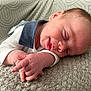 Caleb is registered to the contest to win money with this photo: newborn, baby, sleeping, hand, face, smile, blanket, texture, clothing, collar, couch, headphones, relaxation, infant, soft, cozy, indoors, person, closeup, peaceful