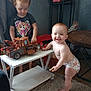 toddler, baby, child, toy, truck, table, diaper, smile, playing, indoor, carpet, furniture, person, cute, expression, hair, shelf, cookie, clothing, room
