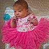 baby, newborn, infant, pink_dress, frilly_skirt, pacifier, quilted_blanket, cute, small_hands, lying_down, indoors, soft_lighting, sleepwear, head, face, person, child, newborn_clothing, adorable, portrait