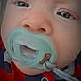 Jameson joined the competition — help win amazing prizes! baby, closeup, pacifier, face, child, infant, expression, blue_eyes, skin, nose, mouth, clothing, red, blue, string, clip, person, young_child, indoors, portrait