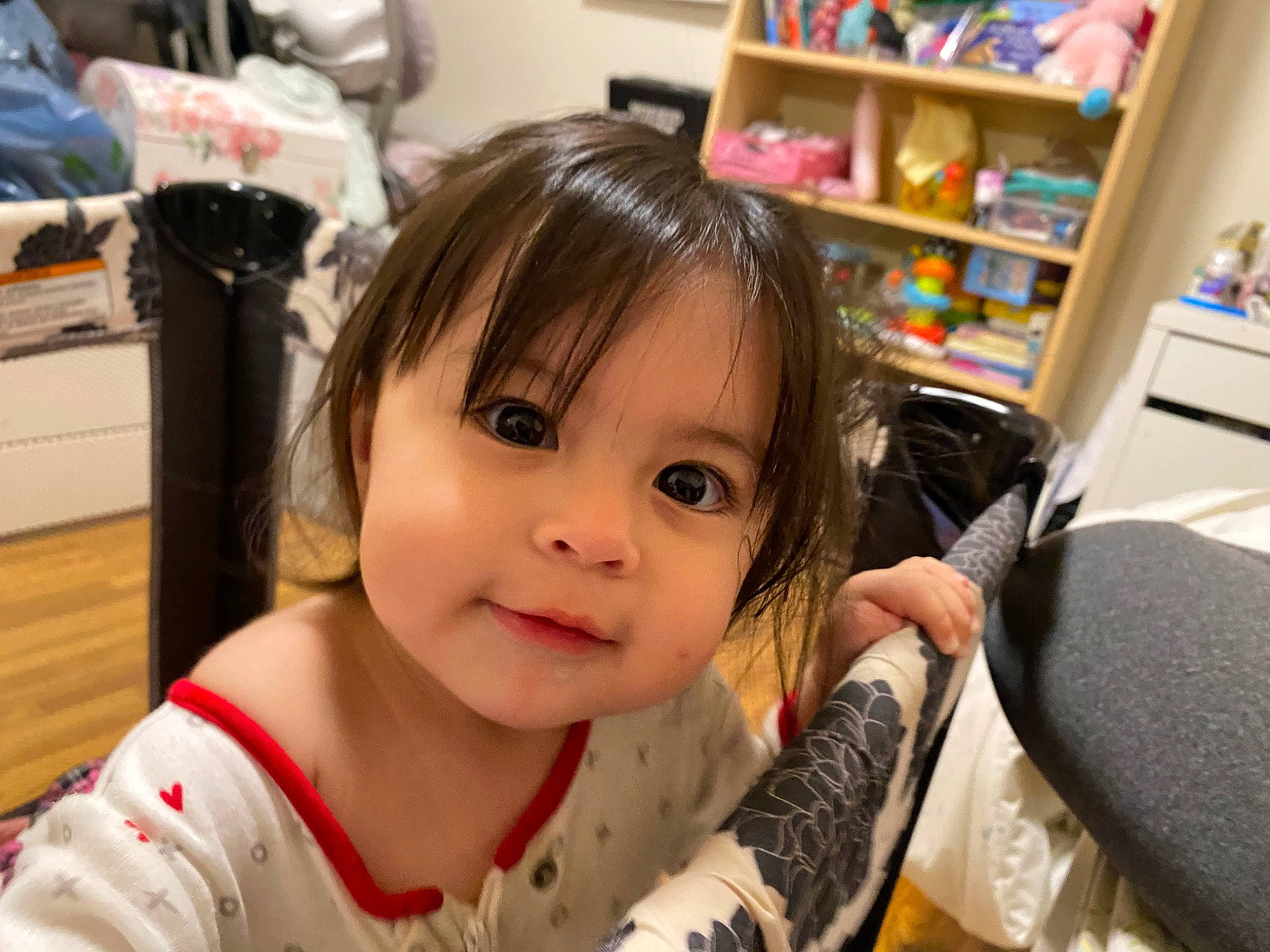 Heavenly is registered to the contest to win money with this photo: baby, baby_toddler_clothing, bangs, bookcase, chair, cheek, child, eyelash, fun, happy, person, publication, room, shelf, shelving, sitting, toddler