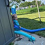 Cohen is registered to the contest to win money with this photo: child, toddler, outdoor, grass, sky, clouds, pool_noodle, chalk_drawing, heart, clothesline, laundry, door, sidewalk, barefoot, blue_clothing, curly_hair, residential_area, tree, plastic_bag, sunny