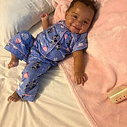 Malia joined the competition — help win amazing prizes! baby, child, infant, smiling, portrait, bed, bedding, blanket, pillow, bedroom, pajamas, cartoon, mickey_mouse, pink, blue, lying_down, indoor, cozy, happy, bottle