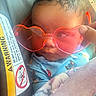 Malia joined the competition — help win amazing prizes! baby, infant, child, face, sunglasses, heart_shaped_sunglasses, portrait, close_up, curly_hair, sleeping, blanket, blue_clothing, colorful, cozy, indoors, vehicle, warning_label, hand, fashion, cute