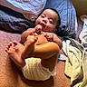 Malia joined the competition — help win amazing prizes! baby, infant, child, diaper, bed, blanket, pillow, bedroom, lying_down, portrait, face, eyes_open, curious, barefoot, toes, hands, indoor, home, close_up, natural_lighting