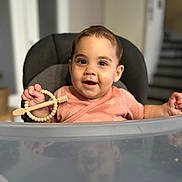 Lia participe au concours pour gagner de l'argent avec cette photo : baby, child, high_chair, toy, wooden_toy, smile, face, indoor, reflection, clothing, short_hair, hand, table, curious, cute, infant, person, seat, background_blur, expression