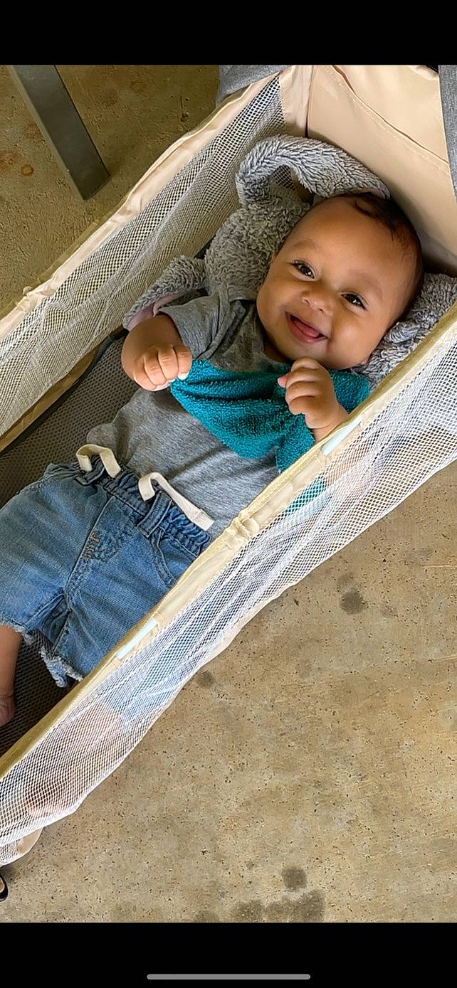 Jarell is registered to the contest to win money with this photo: baby, baby_carriage, baby_products, baby_toddler_clothing, chair, cheek, child, comfort, denim, eye, happy, human, iris, leisure, organ, person, sitting, skin, smile, toddler