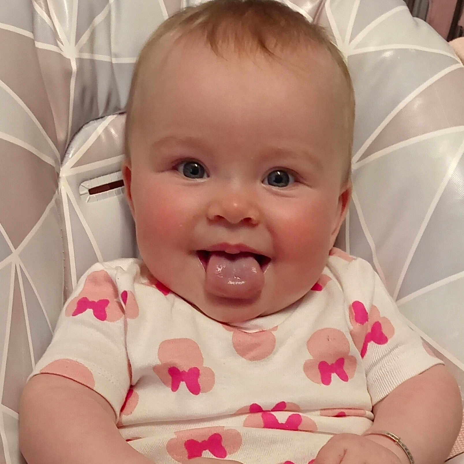 Orlagh joined the competition — help win amazing prizes! baby, blue_eyes, bracelet, chair, cheeks, child, clothing, cute, face, geometric, happy, infant, pattern, person, pink_bows, shirt, sitting, skin, smile, tongue