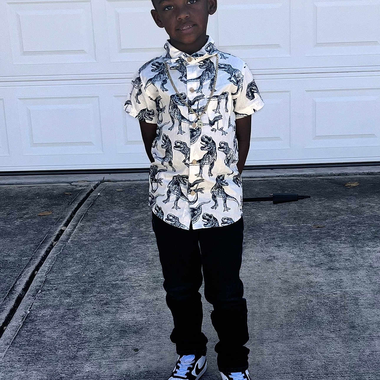 Torryen is registered to the contest to win money with this photo: blackhair, boy, child, clothing, face, footwear, gun, hair, happy, head, jeans, male, pants, person, shoe, sitting, sleeve, sneaker, standing, weapon