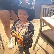 Luna joined the competition — help win amazing prizes! toddler, child, hat, indoor, craft, turkey, jacket, stars, jeans, sneakers, table, chair, floor, adult, person, restaurant, menu, tile_floor, casual, smile