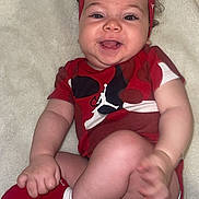 Lina participe au concours pour gagner de l'argent avec cette photo : baby, smiling, headband, bow, red_clothing, socks, diaper, blanket, infant, happy, cute, child, lying_down, playful, face, human, one_person, indoors, skin, closeup