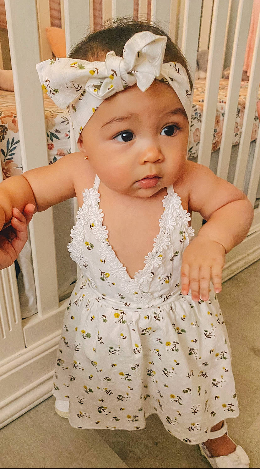 Mila is registered to the contest to win money with this photo: baby, baby_toddler_clothing, cap, child, clothing, day_dress, event, facial_expression, finger, gesture, hand, happy, headband, headpiece, headwear, jewellery, pattern, person, pink, skin