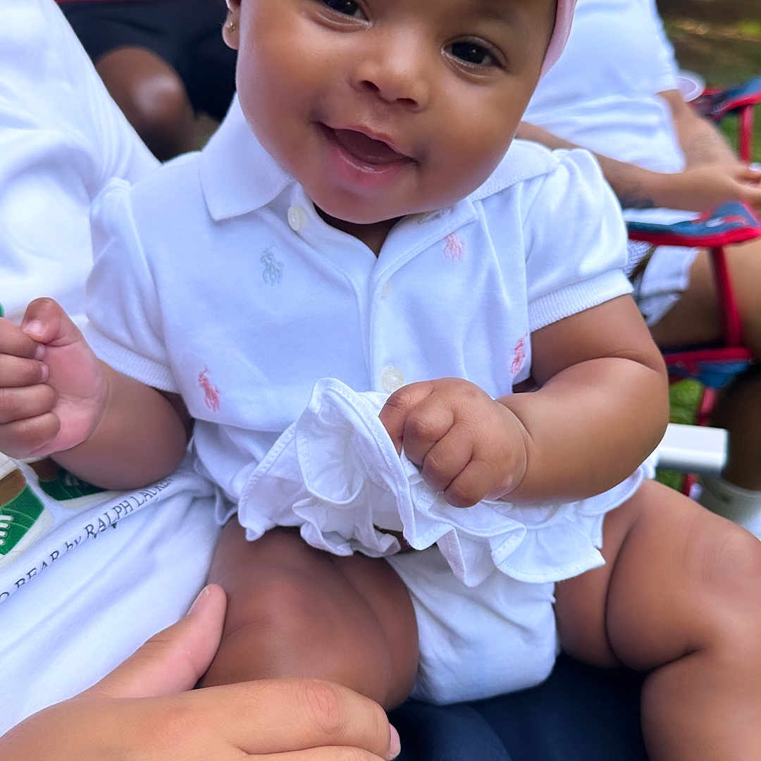 Kalani is registered to the contest to win money with this photo: baby, bodypart, cap, child, clothing, dress, face, female, finger, girl, hand, happy, hat, head, people, person, photography, portrait, shorts, smile