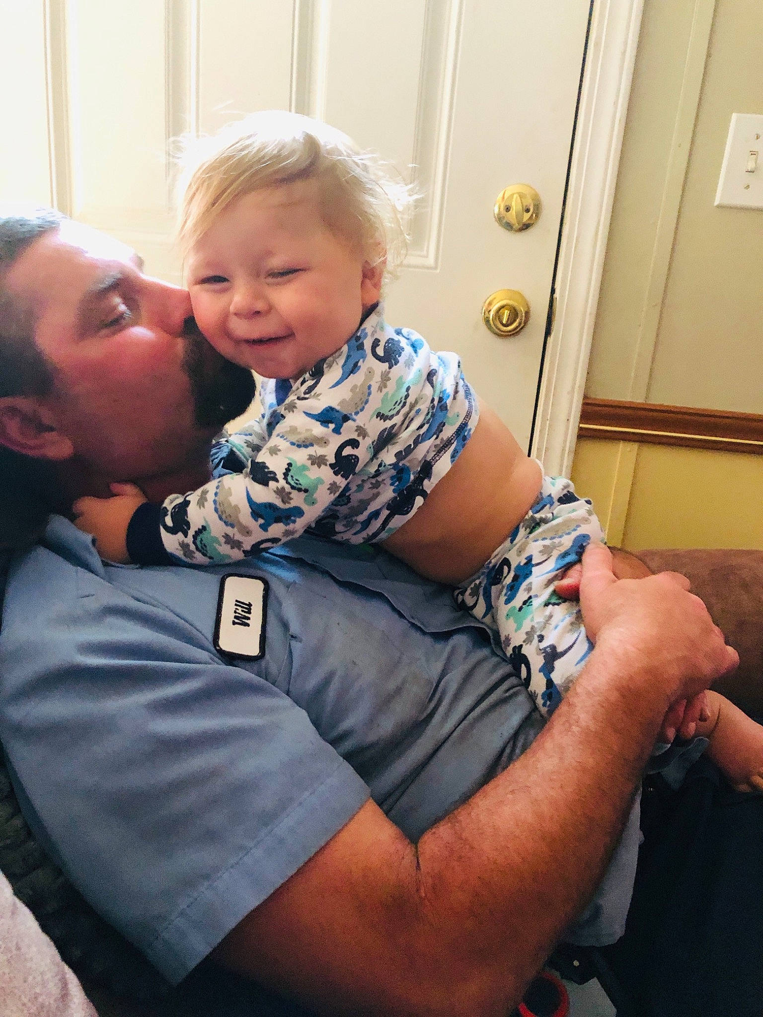 Tanner is registered to the contest to win money with this photo: arm, baby, cheek, comfort, door, face, finger, gesture, hair, happy, human_body, iris, joint, mouth, muscle, person, shoulder, skin, smile, standing