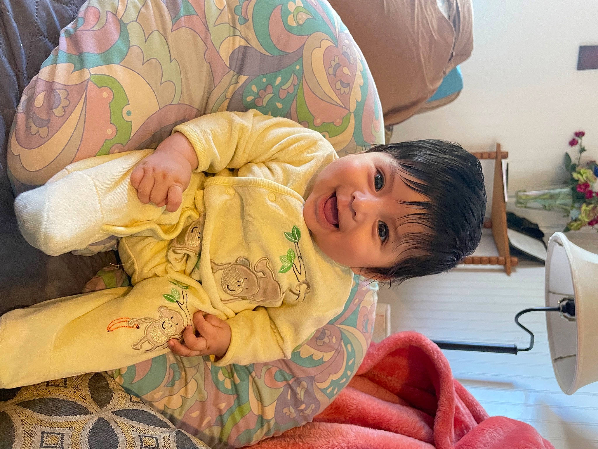Rafael is registered to the contest to win money with this photo: baby, baby_toddler_clothing, child, comfort, couch, eye, facial_expression, finger, flooring, fun, happy, head, human_leg, lap, person, room, sitting, skin, smile, thigh