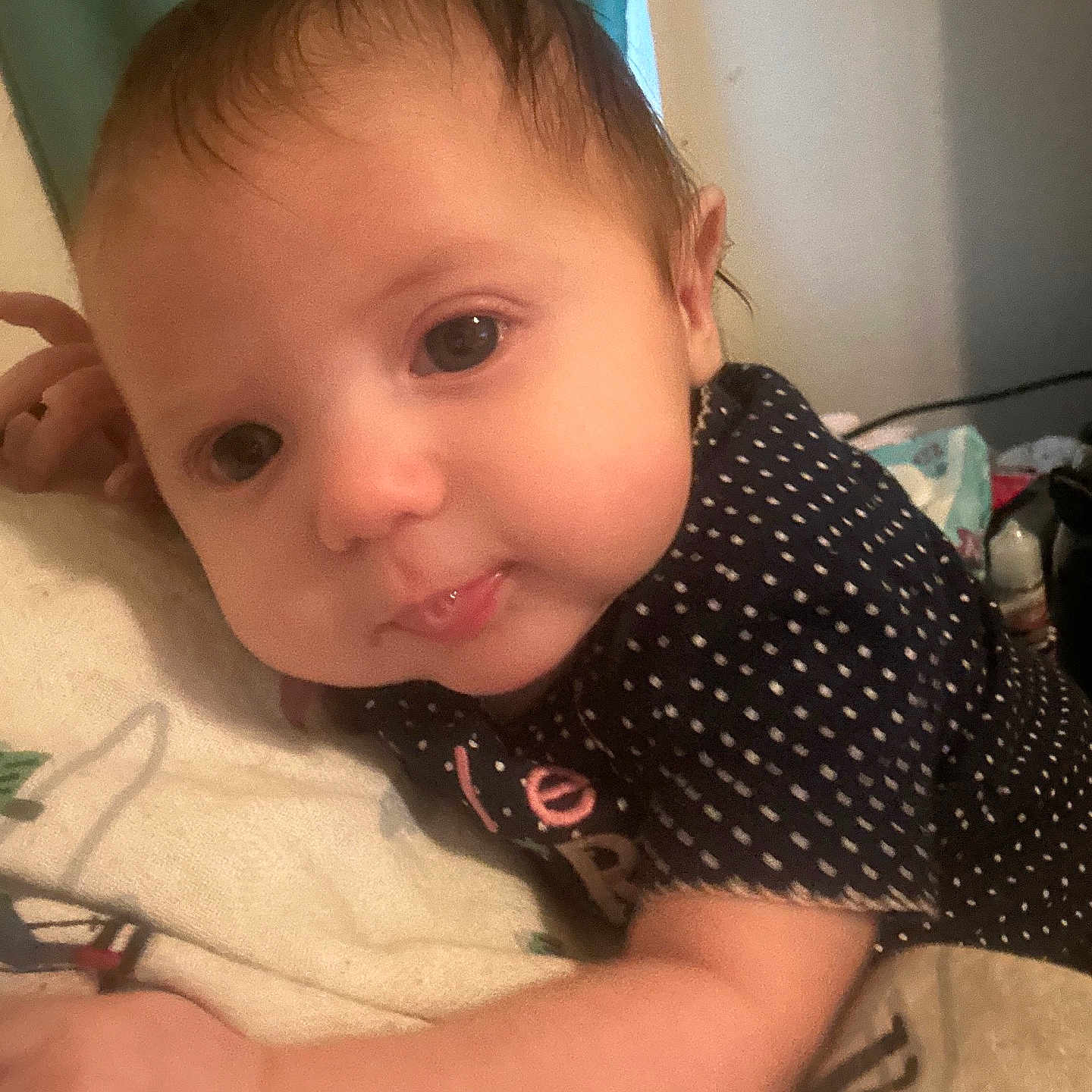 Ramonna joined the competition — help win amazing prizes! baby, bedroom, blanket, closeup, clothing, curious, cute, expression, face, hair, hand, indoors, infant, lying_down, person, polka_dot, skin, soft_lighting, tongue, young_child