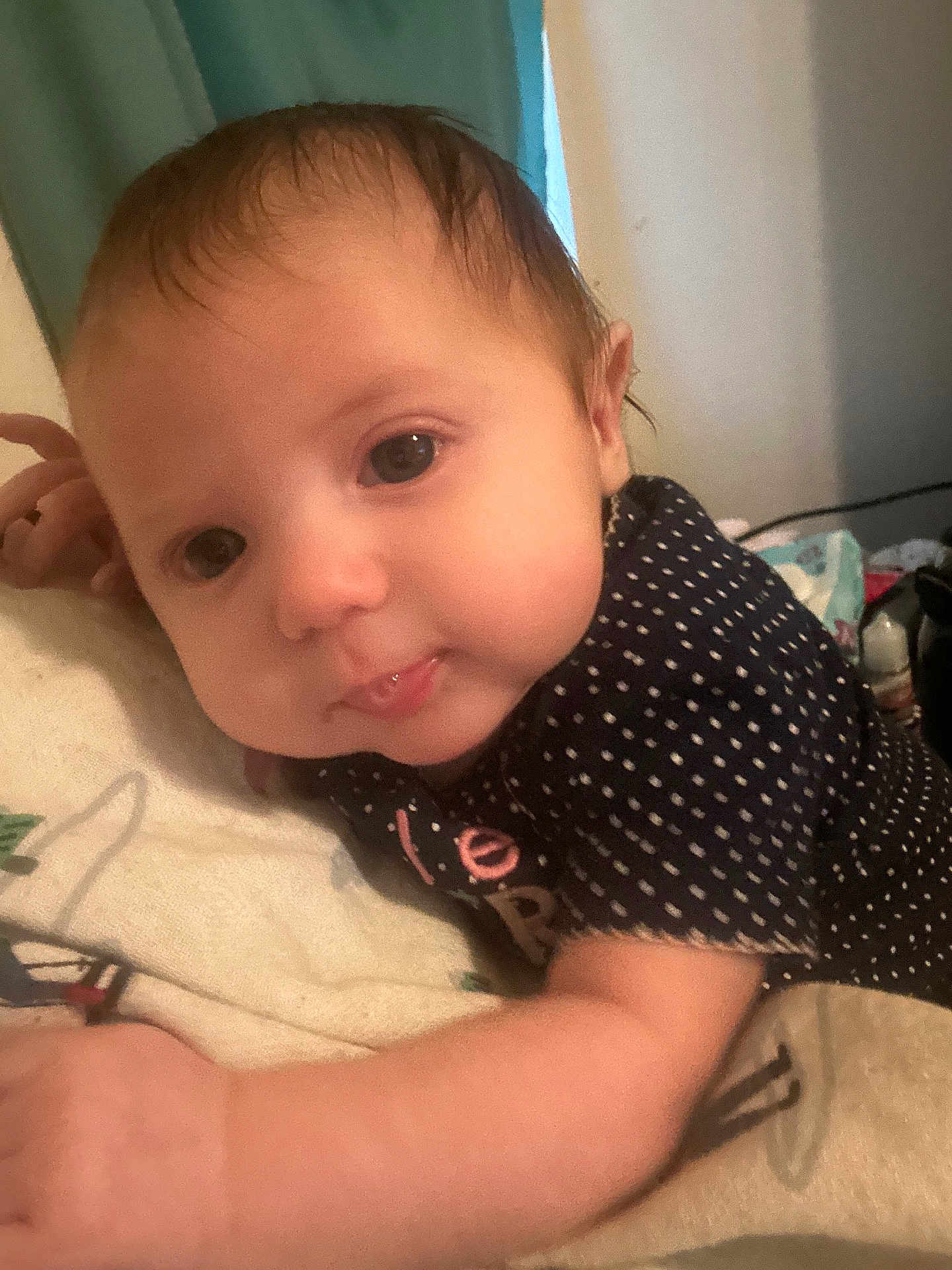 Ramonna joined the competition — help win amazing prizes! baby, infant, face, skin, clothing, polka_dot, hand, lying_down, curious, tongue, soft_lighting, indoors, blanket, closeup, young_child, cute, expression, hair, person, bedroom