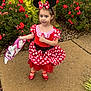 bag, child, concrete, costume, cute, dress, flowers, girl, greenery, headband, minnie_mouse, nature, outdoor, person, polka_dot, portrait, red, shoes, sidewalk, socks
