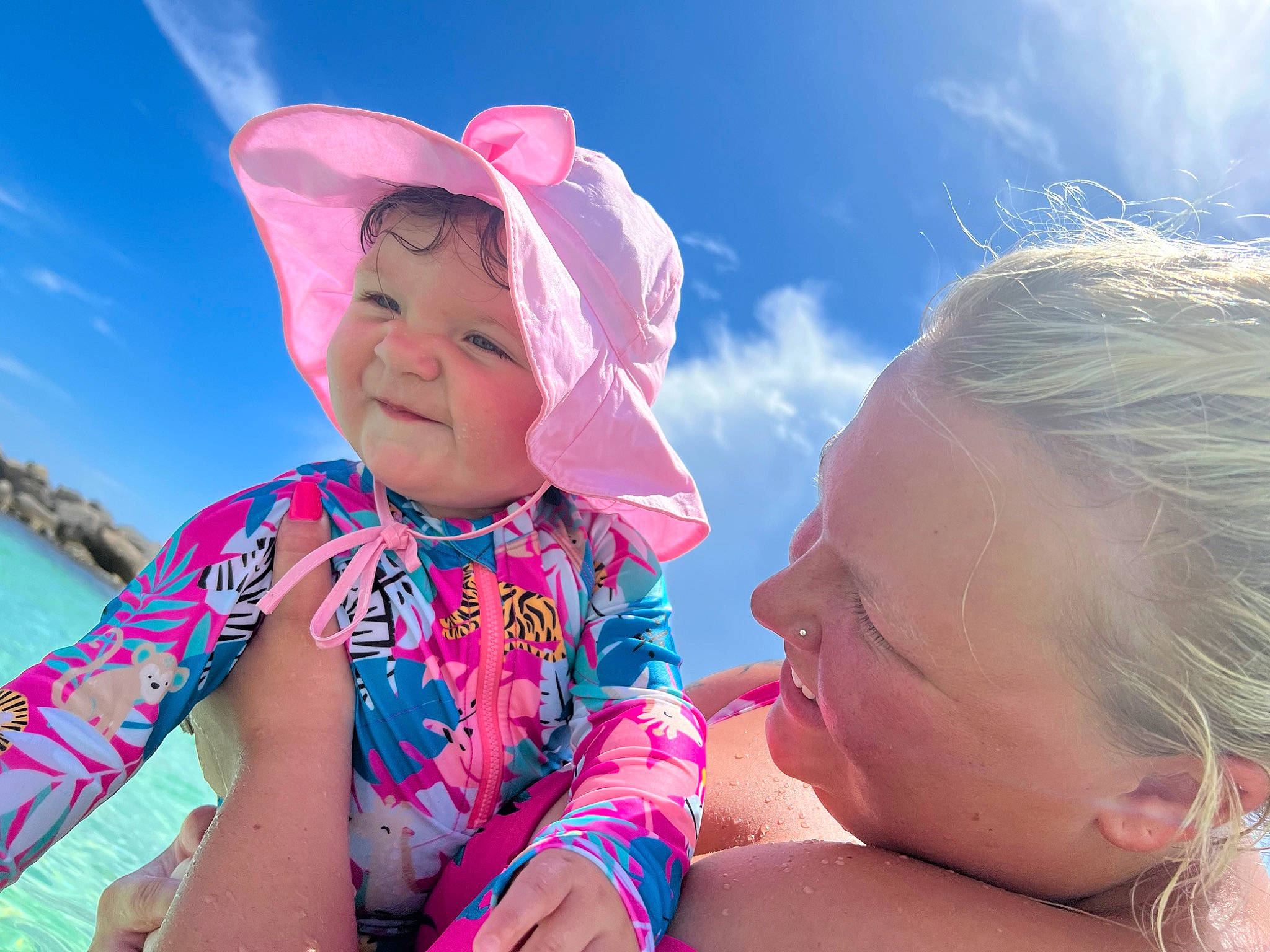 Maci is registered to the contest to win money with this photo: azure, baby, baby_toddler_clothing, child, cloud, eye, flash_photography, fun, happy, hat, headwear, leisure, people_in_nature, person, pink, recreation, sand, skin, sky, sun_hat