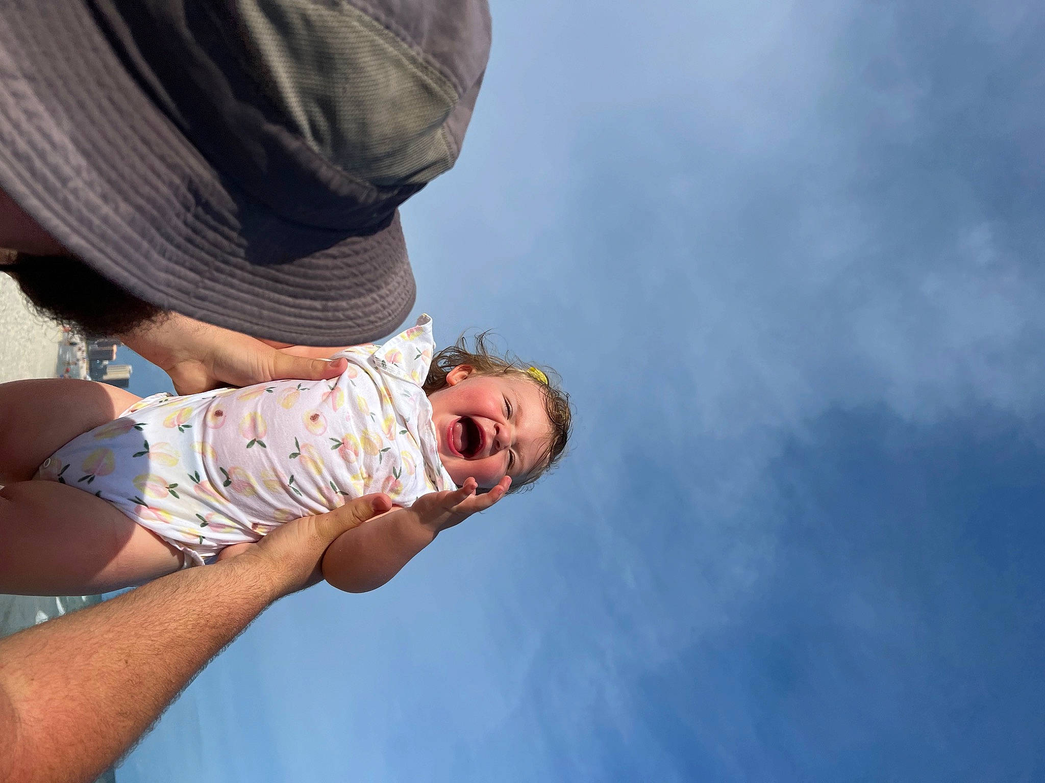 Maci is registered to the contest to win money with this photo: baby, cloud, dress, elbow, eyewear, gesture, glasses, happy, hat, human_leg, leisure, people_in_nature, person, sky, smile, sun_hat, sunglasses, thigh, toddler, tree