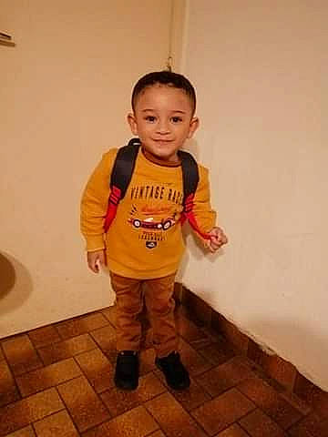 Ethan participe au concours pour gagner de l'argent avec cette photo : baby, baby_toddler_clothing, boot, cheek, child, floor, flooring, fun, happy, hardwood, human_body, joy, leg, nose, person, room, sleeve, smile, standing, t_shirt