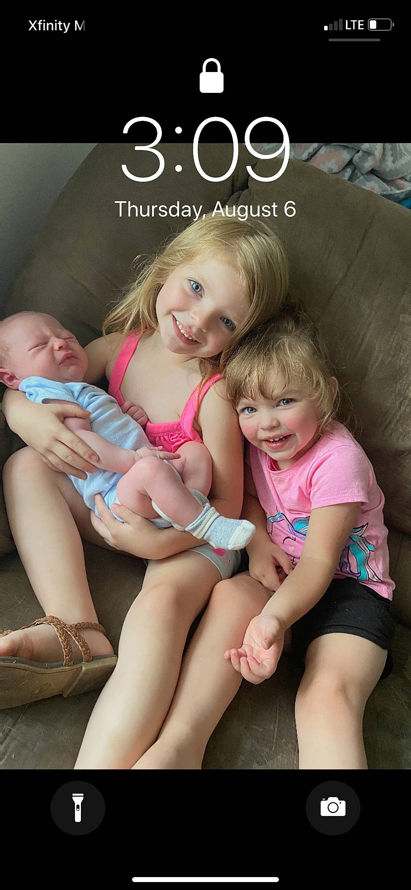 Delaney is registered to the contest to win money with this photo: baby_toddler_clothing, blond, cheek, child, comfort, eye, face, facial_expression, finger, foot, head, joy, lap, organ, person, pink, sitting, skin, thigh, thumb