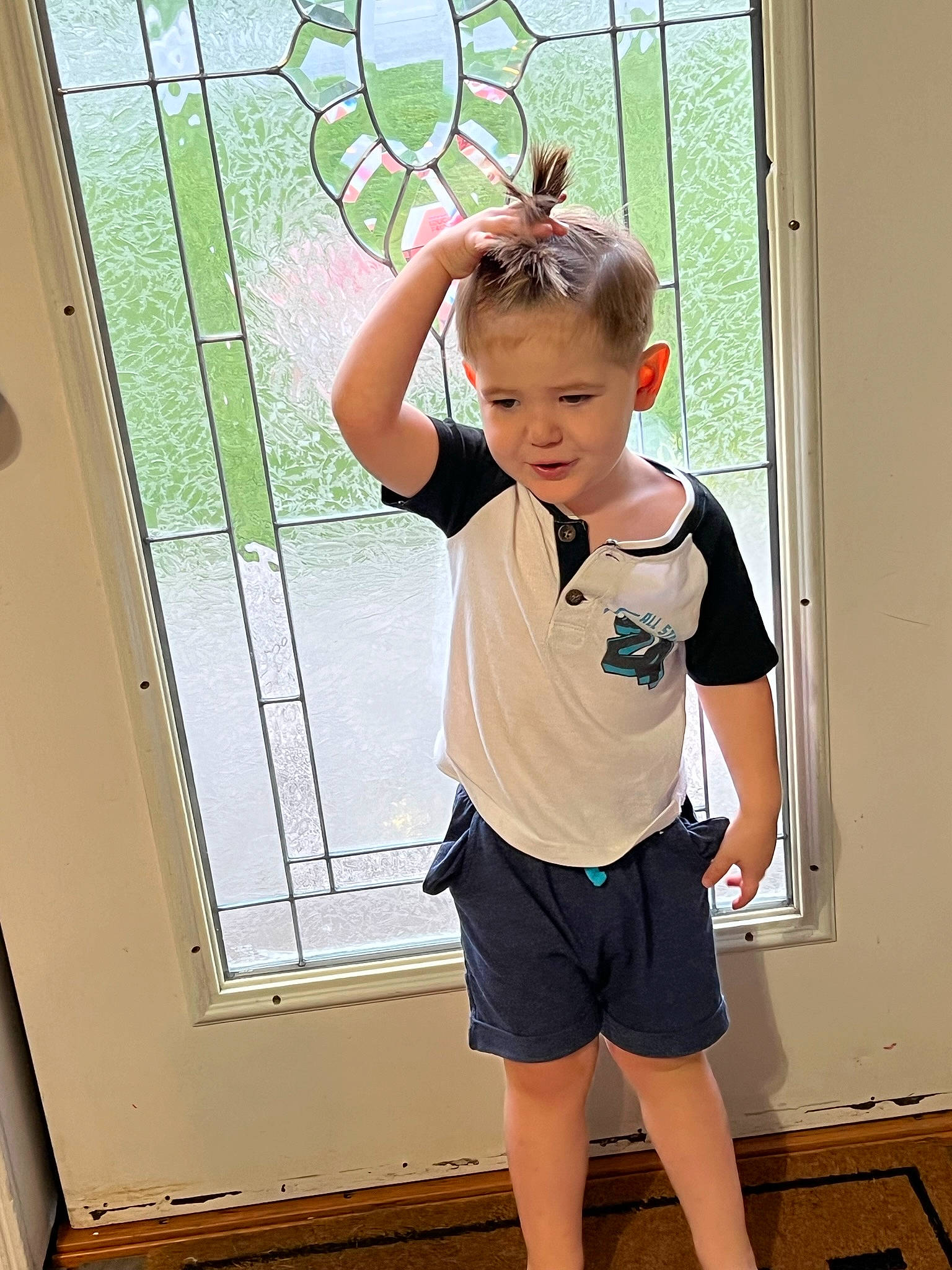 Kamden is registered to the contest to win money with this photo: active_shorts, baby_toddler_clothing, bermuda_shorts, elbow, fun, happy, human_leg, joint, knee, leg, leisure, person, shorts, shoulder, sleeve, thigh, toddler, waist, white, window