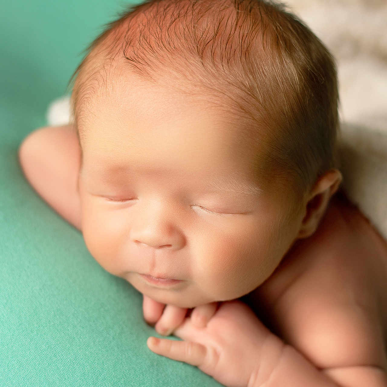 Mavrik joined the competition — help win amazing prizes! newborn, baby, infant, sleeping, peaceful, closeup, face, skin, hand, head, soft, teal_background, portrait, child, cute, resting, calm, young, human, tiny