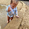 toddler, child, water, sand, stick, swimsuit, outdoor, park, trees, concrete, curved_edge, playing, nature, daylight, young_child, barefoot, muddy, puddle, fence, grass
