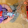 Lilia joined the competition — help win amazing prizes! baby, candid, carpet, casual, child, clothing, curious, floor, indoor, object, person, plastic_wrap, playtime, purple_shirt, puzzle_box, sitting, toddler, toy, water_bottle, young_child