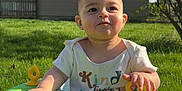 Zayn is registered to the contest to win money with this photo: baby, child, walker, green, outdoor, grass, sunlight, tree, house, fence, person, sneakers, shirt, play, daytime, nature, smile, face, young, cute