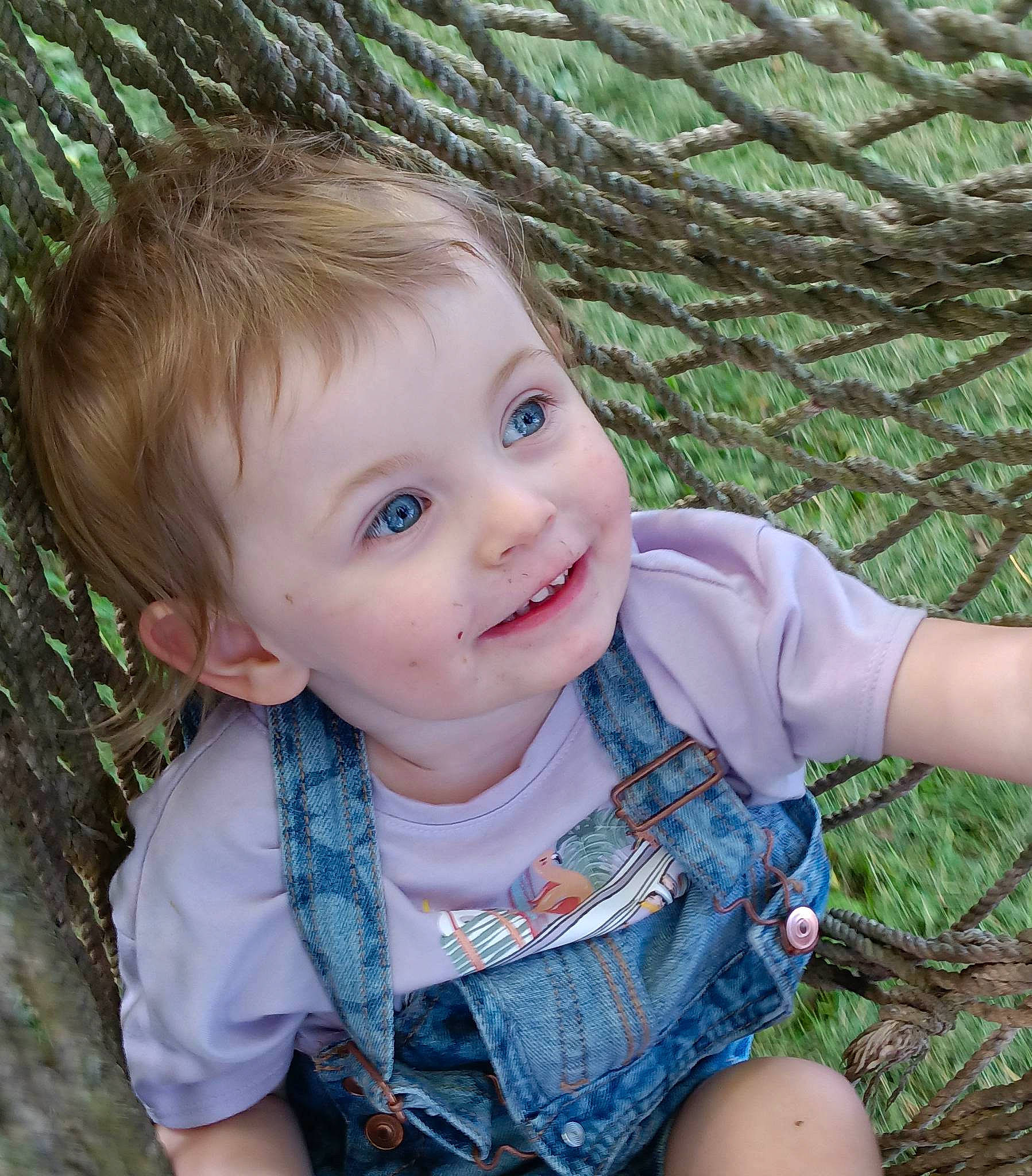Autumn is registered to the contest to win money with this photo: baby_toddler_clothing, cheek, chin, cool, face, grass, green, happy, head, iris, leaf, lip, nose, organ, people_in_nature, person, plant, skin, smile, toddler