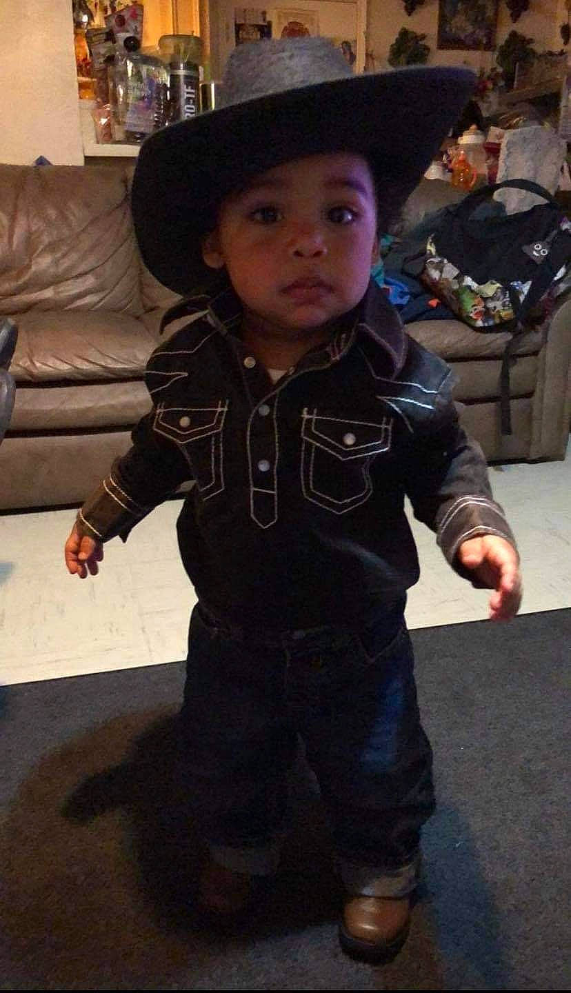 Jeremiah is registered to the contest to win money with this photo: baby, baby_toddler_clothing, cheek, child, costume, couch, fashion_accessory, flooring, fun, fur, hat, headwear, jacket, lamp, leather, person, personal_protective_equipment, sitting, sleeve, sofa_bed