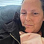 Loki is registered to the contest to win money with this photo: person, cat, kitten, black_cat, couch, blanket, jacket, zipper, window_blinds, indoor, close_up, face, pet, snuggling, cozy, relaxed, fur, comfort, home, casual