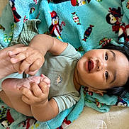 Ethan joined the competition — help win amazing prizes! baby, blanket, child, colorful, cute, dinosaur, expression, feet, hands, happy, indoors, infant, lying_down, onesie, penguin_pattern, playful, portrait, smiling, soft_texture, toddler