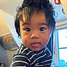 Ethan joined the competition — help win amazing prizes! baby, blue_shirt, blurred_background, child, curly_hair, cute, expression, face, hair, hand, holding, indoor, map, person, portrait, striped_clothing, striped_shirt, tongue_out, window, young