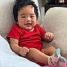 baby, child, smiling, red_clothing, socks, chair, indoor, furniture, happy, cute, infant, portrait, cozy, candle, home, relaxed, person, skin, head, hair