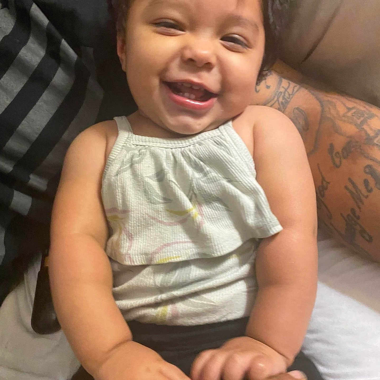 Rosie is registered to the contest to win money with this photo: accessories, baby, babylaughing, clothing, crying, face, happy, head, jewelry, laughing, necklace, person, photography, portrait, sad, skin, sleeve, smile, t_shirt, tattoo