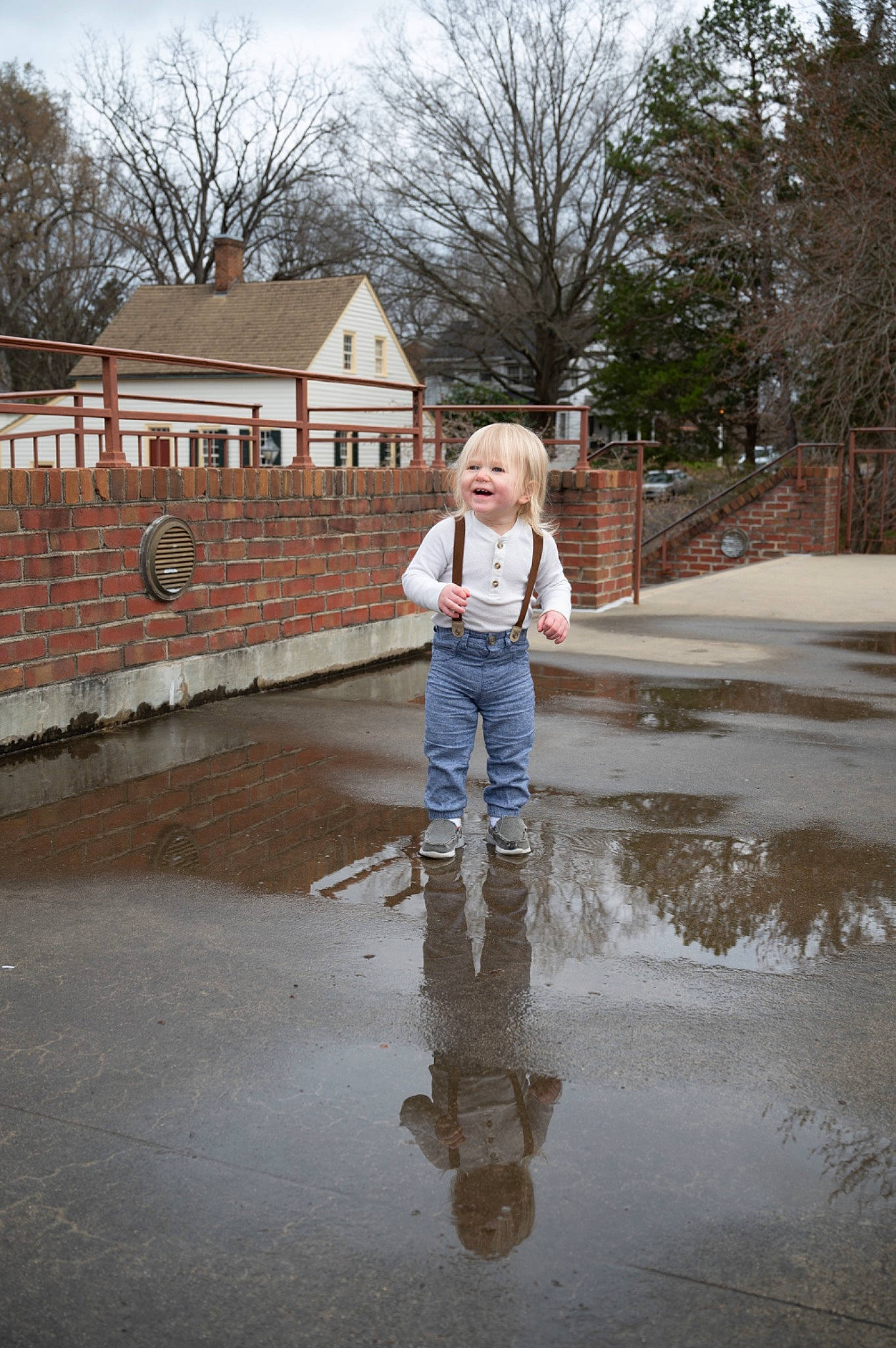 Maverick is registered to the contest to win money with this photo: asphalt, child, denim, fountain, freezing, fun, grass, house, joy, leisure, pattern, person, puddle, reflection, road_surface, sky, toddler, tree, vacation, water
