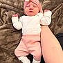 baby, sleeping, infant, pink_clothing, white_socks, turban, flower_accessory, hand, blanket, soft_texture, cozy, newborn, cute, resting, human, portrait, indoors, warm_colors, baby_girl, support