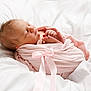newborn, baby, sleeping, pink_blanket, bow, wrapped, infant, soft, cozy, white_bedding, peaceful, cute, tiny_hands, tiny_feet, portrait, closeup, resting, indoors, warm, comfort