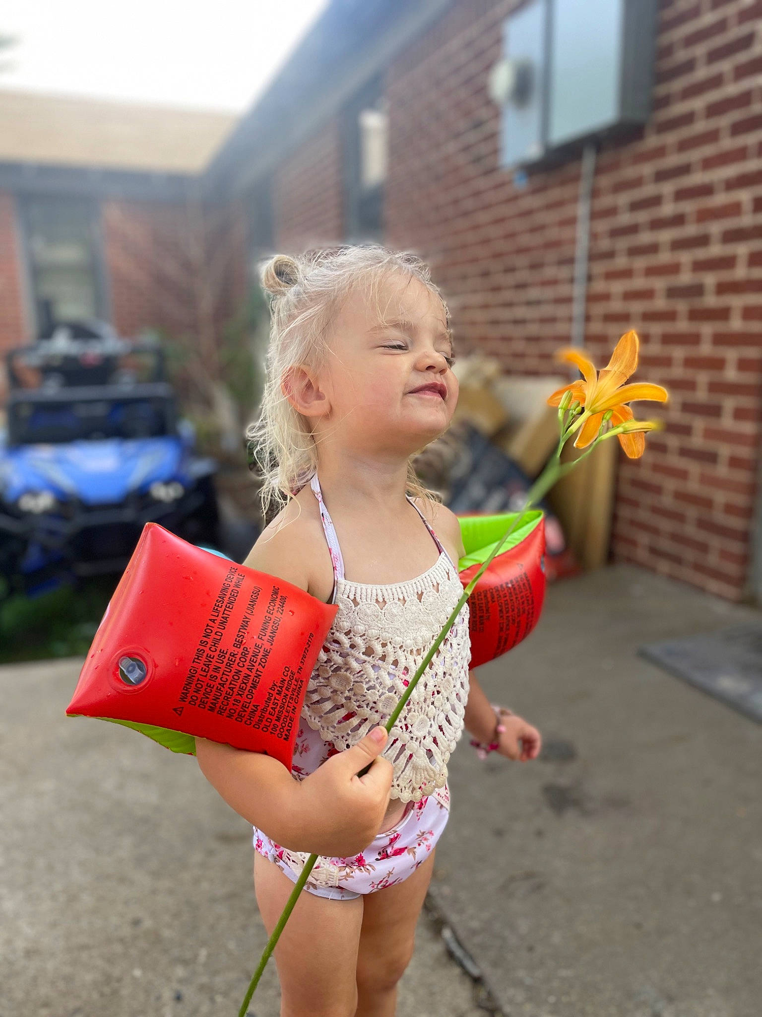 Nebula is registered to the contest to win money with this photo: barefoot, brick, child, entertainment, event, flower, fun, grass, happy, human_leg, leisure, performing_arts, person, plant, play, recreation, sandal, sitting, summer, toddler