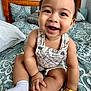 baby, babylaughing, bed, bedroom, clothing, face, furniture, happy, head, hosiery, indoors, laughing, person, photography, portrait, room, sitting, sleeve, smile, sock