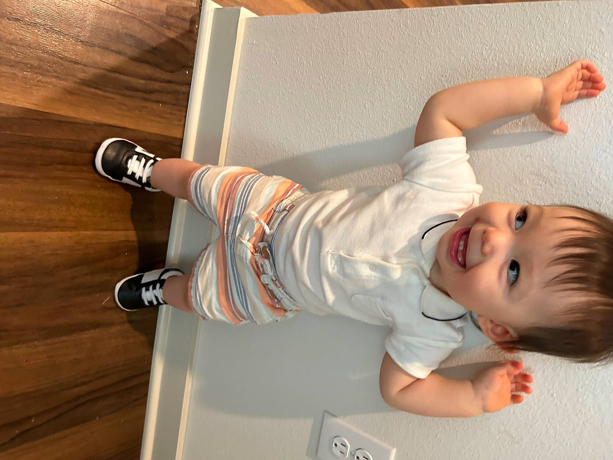 Julian joined the competition — help win amazing prizes! arm, baby, baby_toddler_clothing, comfort, elbow, floor, flooring, foot, hardwood, human_leg, joint, joy, knee, leg, person, sleeve, smile, sock, thigh, toddler