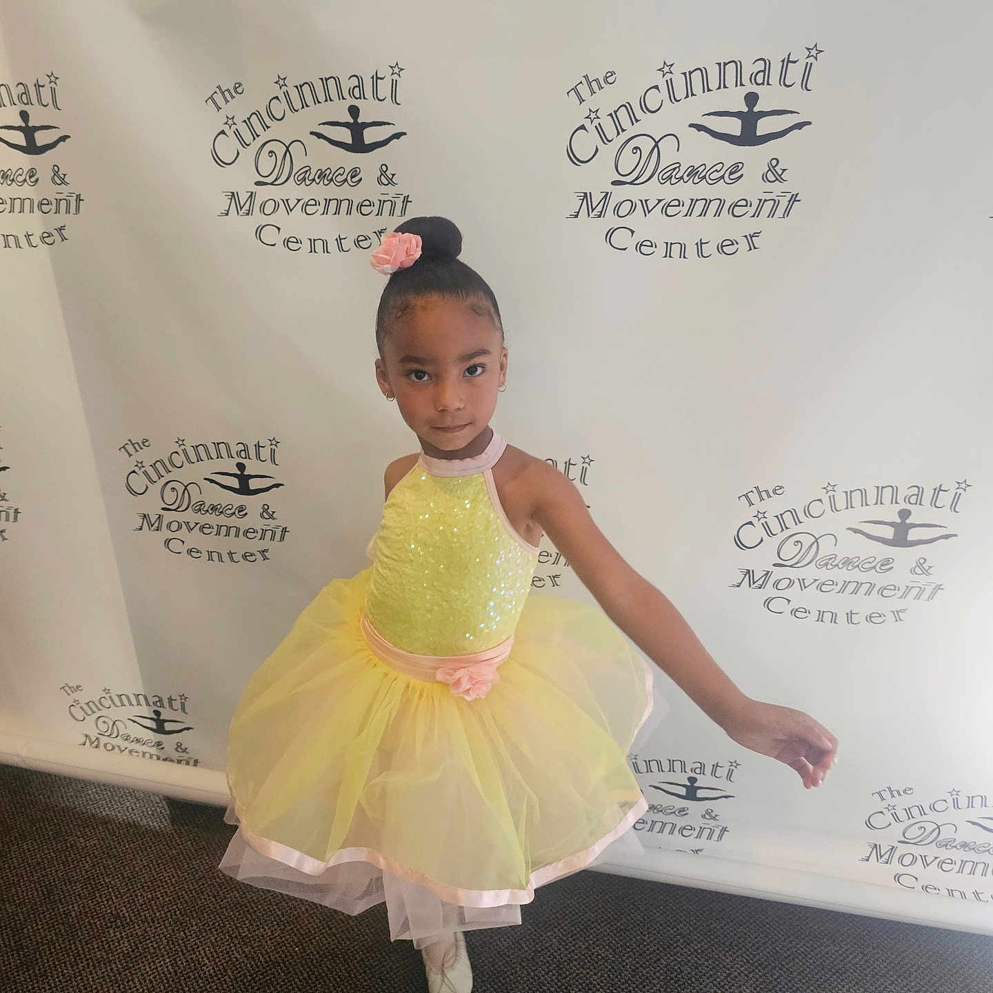 Journi is registered to the contest to win money with this photo: artistic, backdrop, ballet, carpet, child, confident, dance, flower_accessory, footwear, girl, hair_bun, indoor, logo, performance, pose, smile, studio, tutu, yellow_dress, young_dancer
