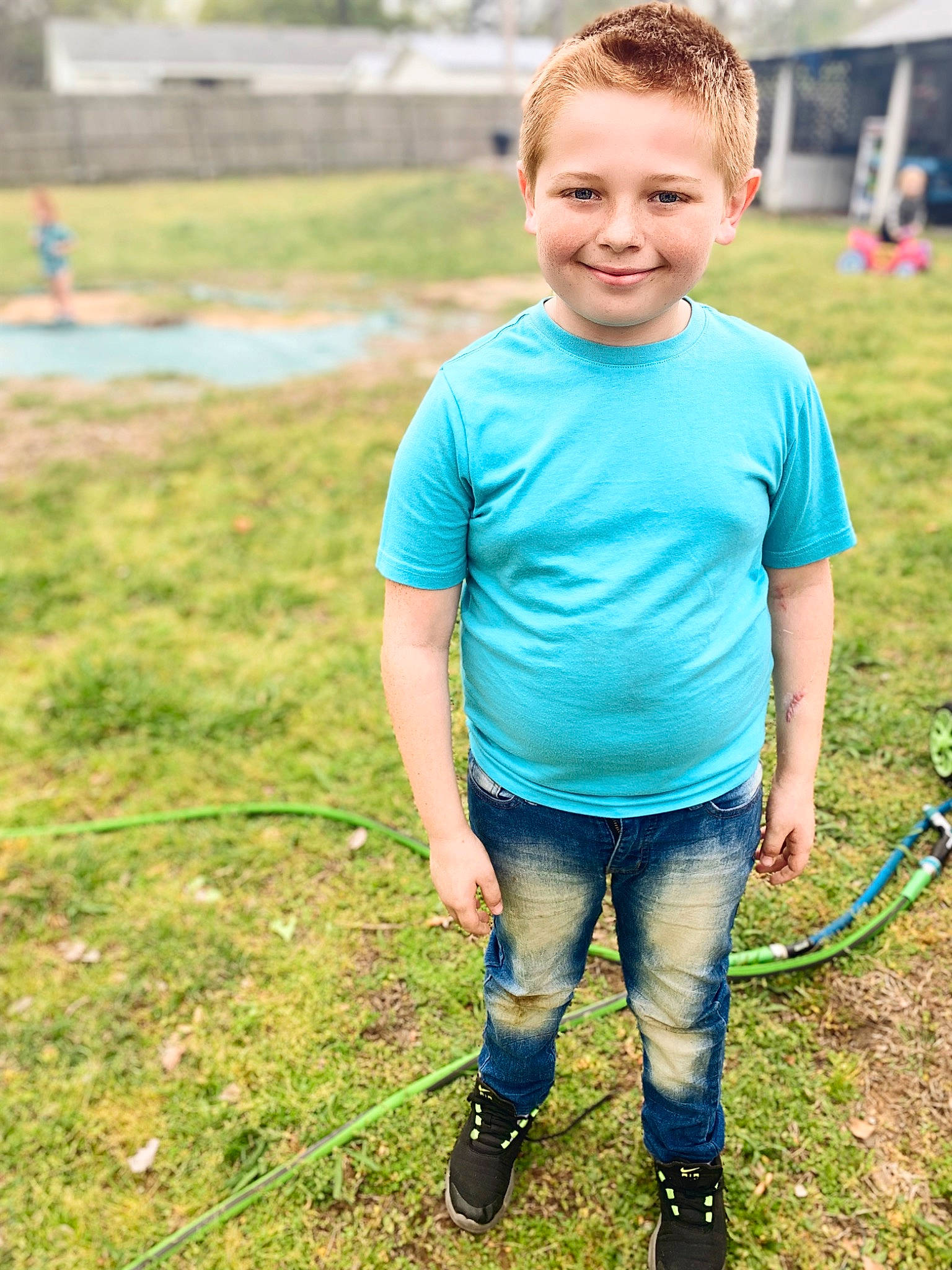 Levi is registered to the contest to win money with this photo: boot, child, electric_blue, fun, grass, grass_family, grassland, green, happy, joy, leisure, people_in_nature, person, plant, recreation, shoe, shorts, sleeve, smile, summer