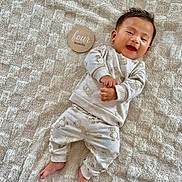 Stefano joined the competition — help win amazing prizes! baby, bear_pattern, blanket, child, clothing, cozy, cute, feet, four_months, hands, happy, indoors, infant, lying_down, pajamas, portrait, smiling, soft_lighting, texture, wooden_sign